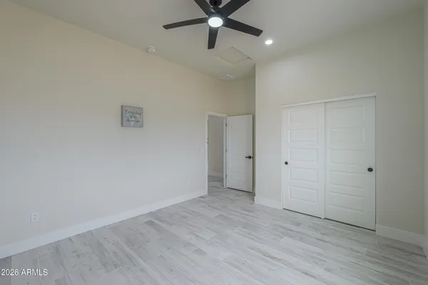 an empty room with windows and closet