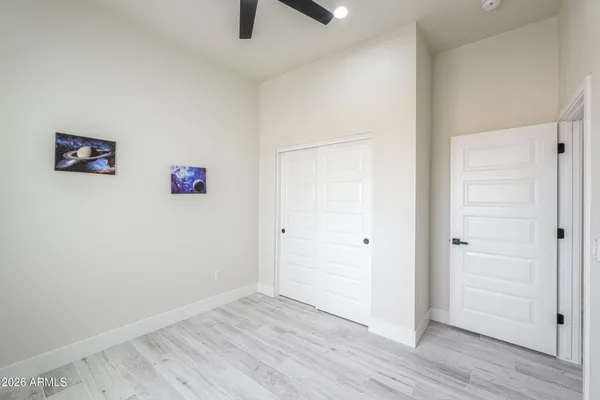 a view of a big room with wooden floor closet and windows