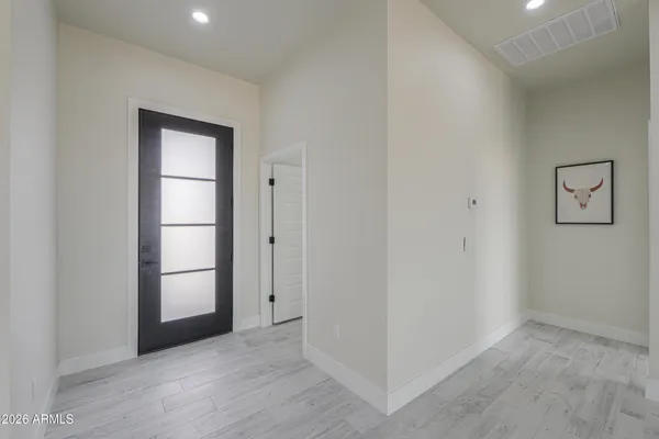 a view of walk in closet with wooden floor