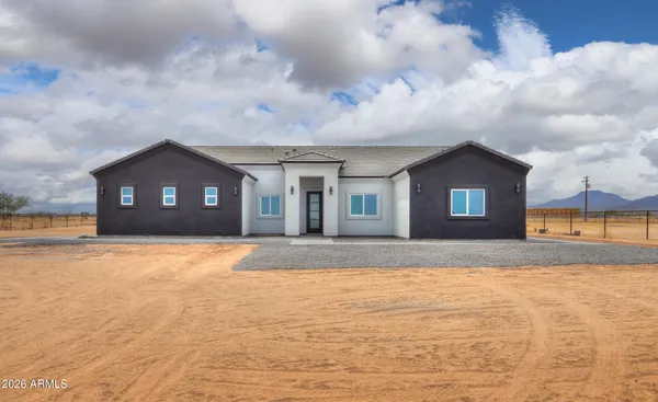 a view of a house with a yard and garage