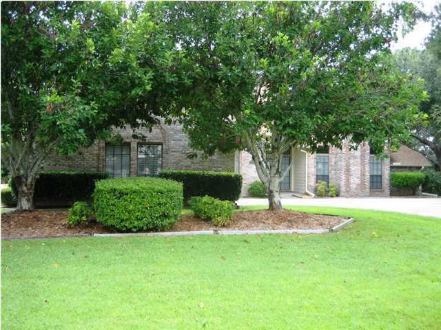 107 Bermuda Way Niceville, FL 32578 - Photo 1 of 19 a garden with trees in front of it