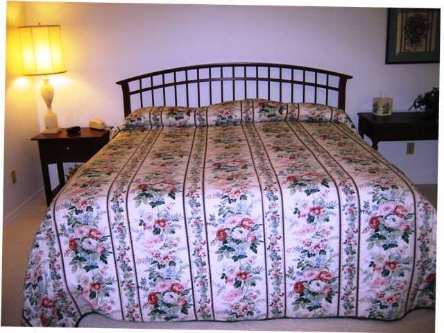 107 Bermuda Way Niceville, FL 32578 - Photo 11 of 19 a bedroom with a bed and a lamp on dresser