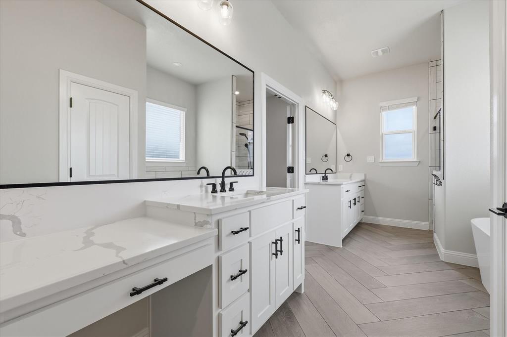 120 Grace Vw Road Weatherford, TX 76088 - Photo 18 of 40 Dual vanity with white cabinetry, quartz countertops, and matte black fixtures