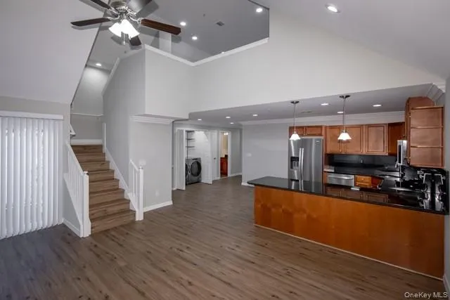 a view of a living room with wooden floor and staircase