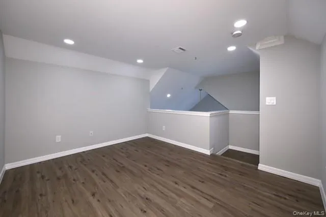an empty room with wooden floor