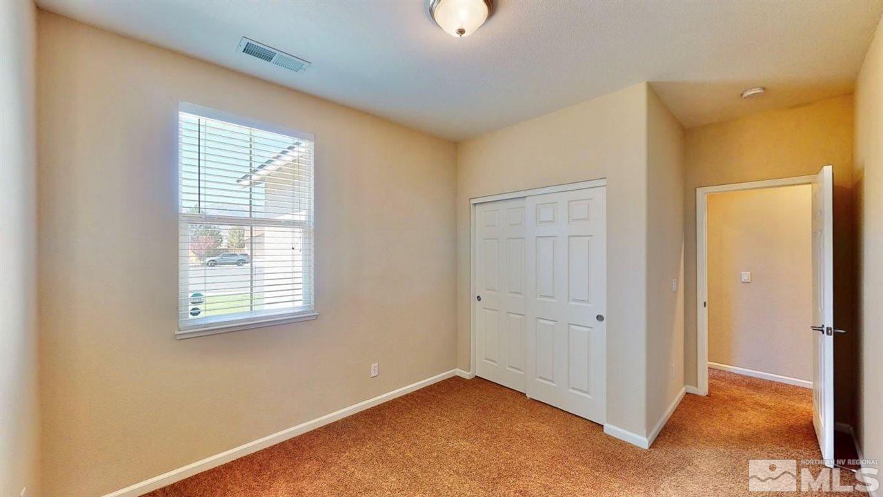 9196 Raytheon Court Reno, NV 89506 - Photo 6 of 23 an empty room with windows and closet
