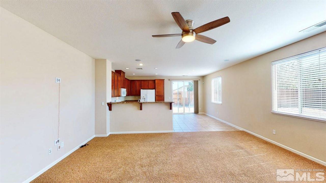 9196 Raytheon Court Reno, NV 89506 - Photo 8 of 23 a view of a livingroom with a ceiling fan and window