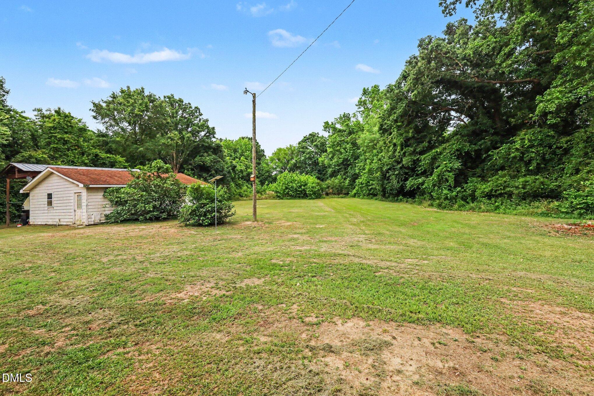 977 Stevens Mill Road Goldsboro, NC 27530 - Photo 4 of 31 a view of a house with a yard and a garage