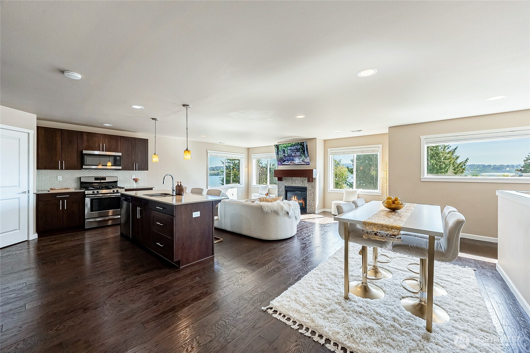 11501 87th Avenue South Seattle, WA 98178 - Photo 2 of 30 a kitchen with kitchen island granite countertop wooden floor and stainless steel appliances
