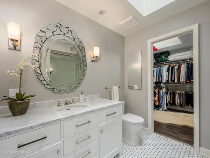 a spacious bathroom with a granite countertop double vanity sink and a mirror