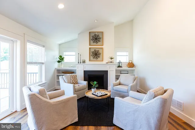 a living room with furniture a window and a fireplace