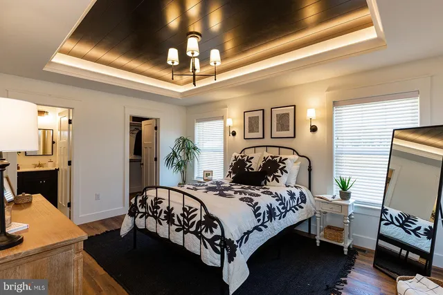 a bedroom with bed and a chandelier