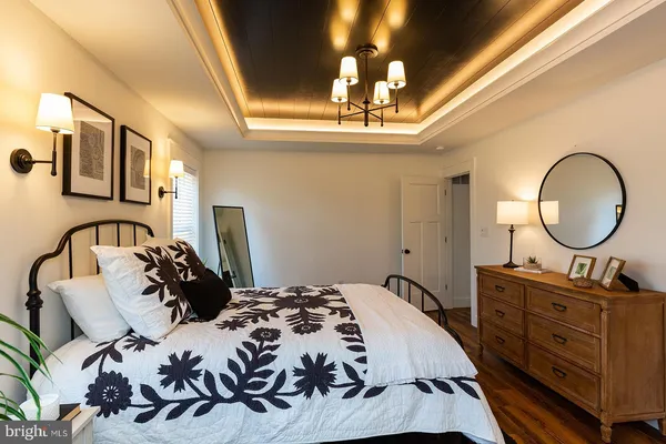 a bedroom with bed and a chandelier