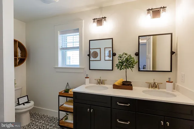 a bathroom with a toilet sink and mirror