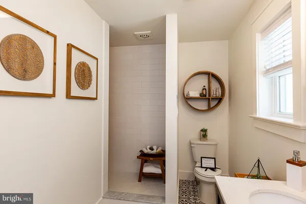 an outdoor space with a front view of a door and a mirror