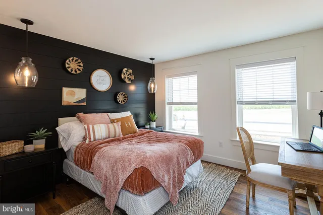 a bedroom with a bed a window and chair