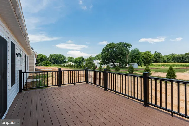 a balcony with wooden floor and fence