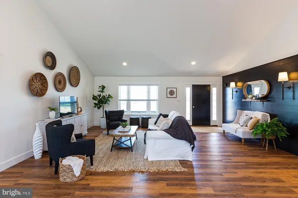 a living room with fireplace furniture and a wooden floor
