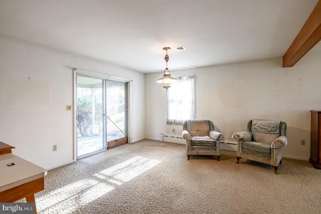 a living room with furniture a window and kitchen view