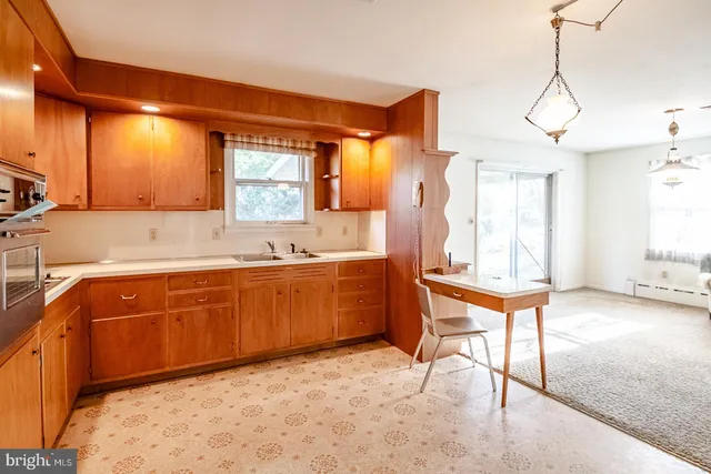 a kitchen with a sink cabinets and window