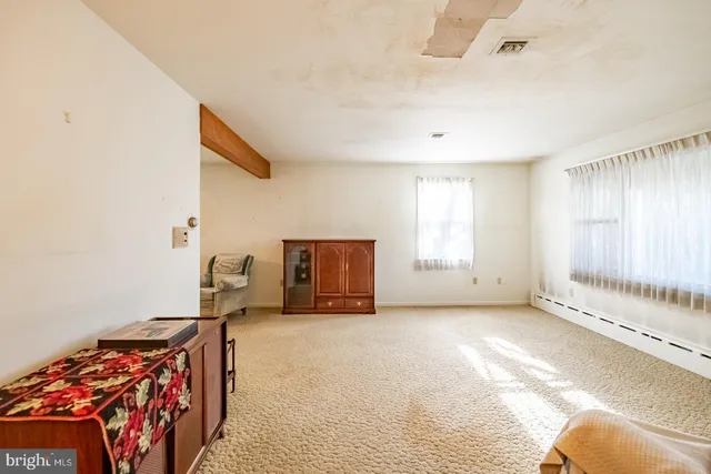 a spacious bedroom with a bed and a large window