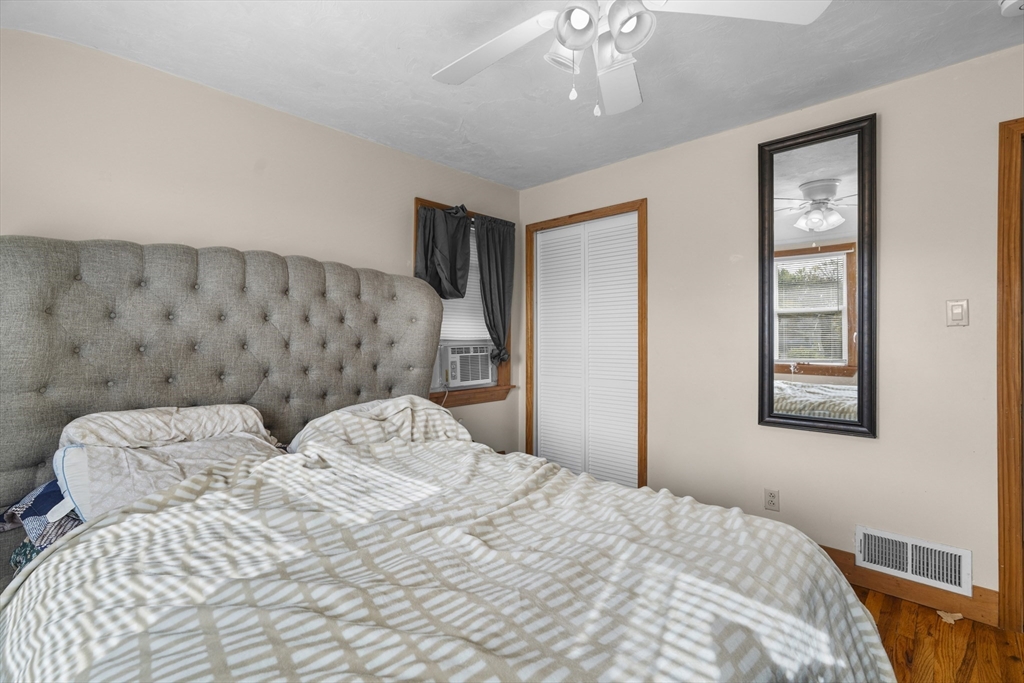 19-21 Bursley Road Weymouth, MA 02191 - Photo 13 of 33 a bedroom with a large bed and a chandelier