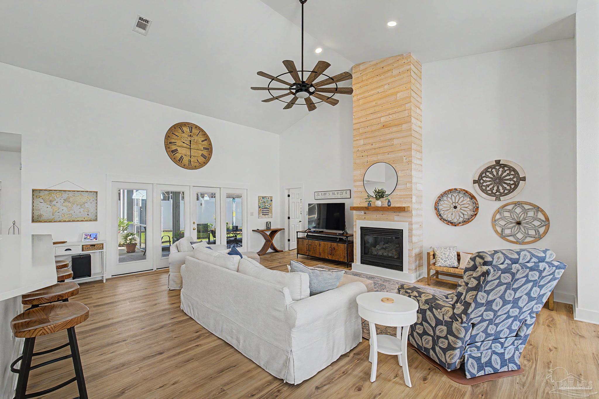 2005 Riviera Lane South Navarre, FL 32566 - Photo 4 of 70 a living room with furniture a fireplace and wooden floor