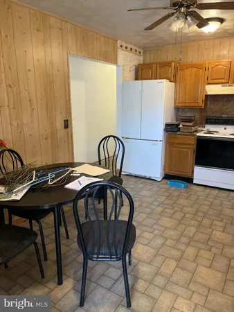 a kitchen with a table chairs and a refrigerator