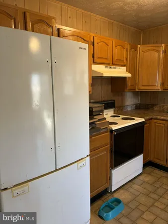 a kitchen with stainless steel appliances a refrigerator sink and cabinets