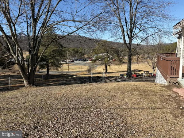 a view of a yard with wooden fence