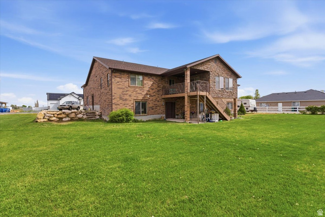 6237 West 4600th Street South Hooper, UT 84315 - Photo 41 of 48 Rear view of property featuring a patio, brick siding, and a balcony