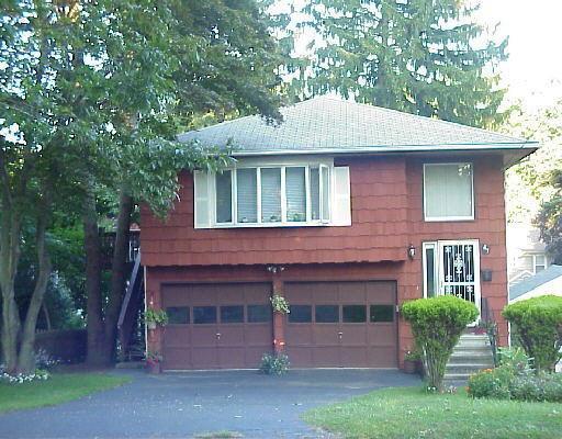 47 George Avenue Norwalk, CT 06851 - Photo 1 of 1 a front view of a house with garden
