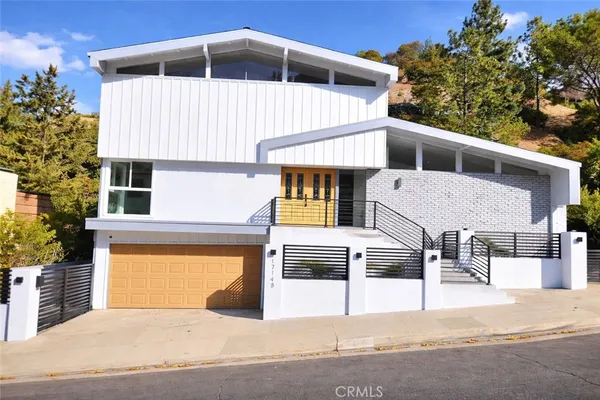 a front view of a house with a garage