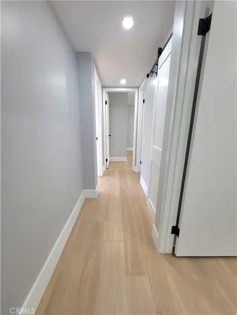 a view of a hallway with wooden floor
