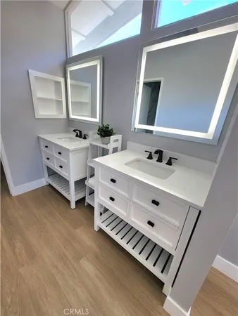 a bathroom with a double vanity sink and mirror