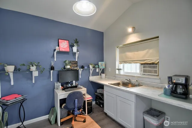 a kitchen with a sink cabinets and window