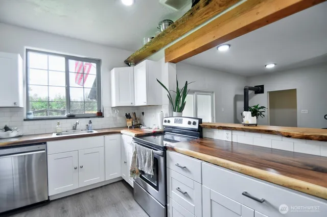 a kitchen with a sink stove and cabinets