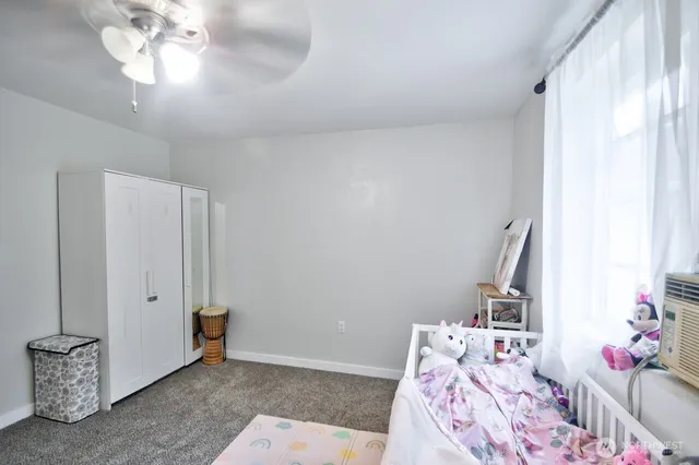 a bed room with a bed and a chandelier