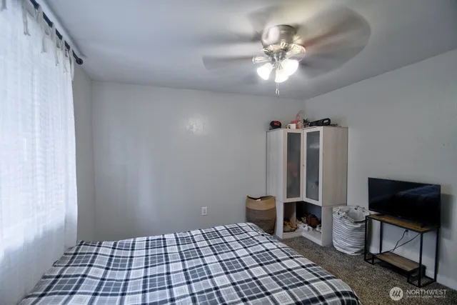 a view of a bedroom with furniture and a window