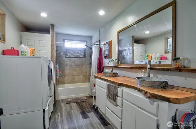 a bathroom with a sink a large mirror and a shower