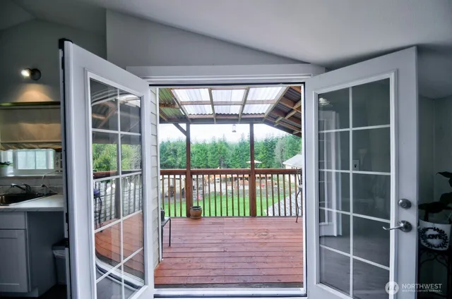 a view of porch with a floor to ceiling window and wooden floor
