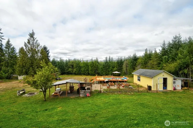 a view of a house with a yard and sitting area