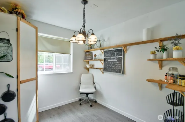 a view of a workspace with furniture and chandelier
