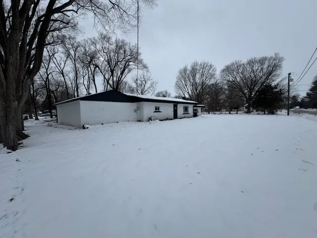 a view of white house with a yard