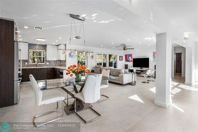 a dining room with furniture a chandelier and pool table