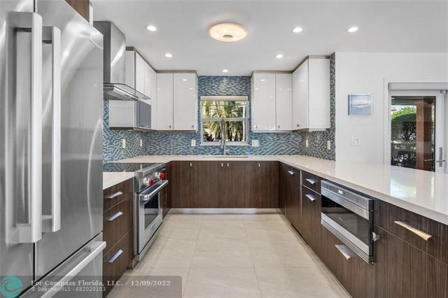 a living room with furniture a flat screen tv and a large window