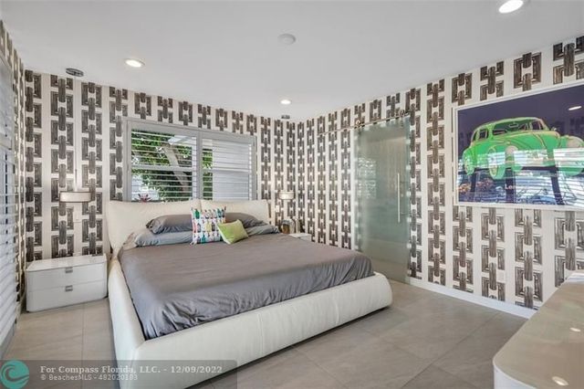 a bedroom with a large bed and a large window