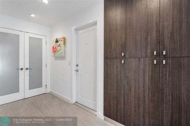 a living room with furniture large window and flat screen tv