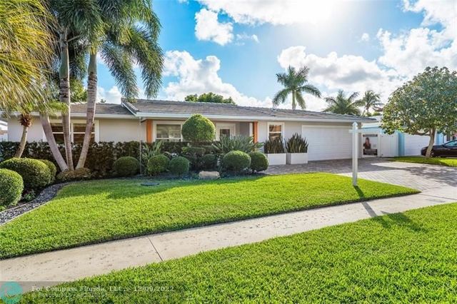 a view of a house with pool and sitting area