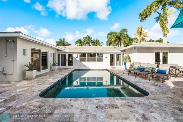 a view of a patio with couches table and chairs and potted plants